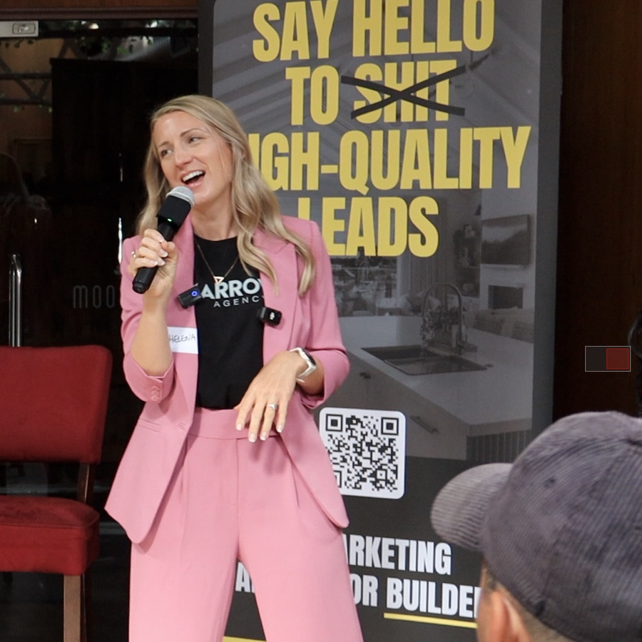 Helena Tivey speaking with a microphone in front of an Arrow Agency banner